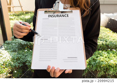Women in suit show insurance policy and pointing 20994215
