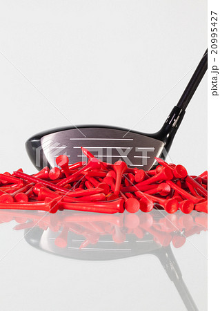 Golf driver and wooden tees on a glass desk Golf driver and wooden tees on a glass desk 20995427