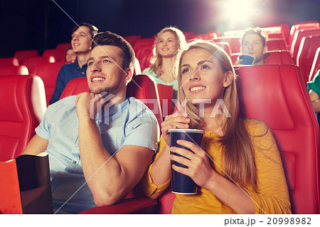 happy friends watching movie in theater 20998982