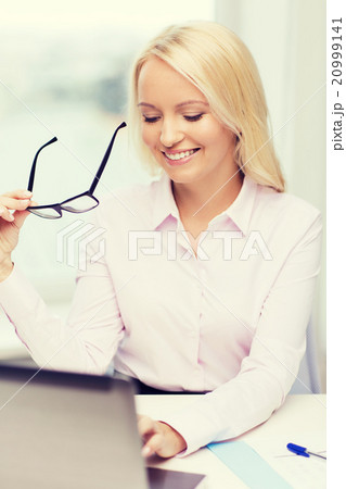 smiling businesswoman or student with laptop smiling businesswoman or student with laptop 20999141