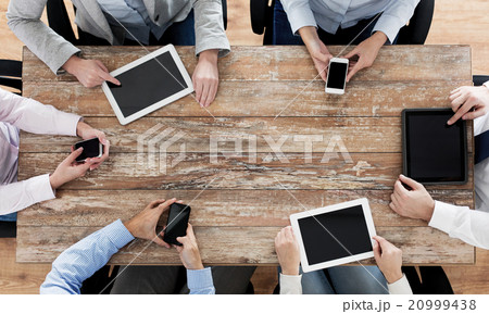 business team with smartphones and tablet pc business team with smartphones and tablet pc 20999438