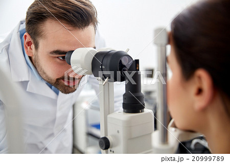 optician with tonometer and patient at eye clinic optician with tonometer and patient at eye clinic 20999789