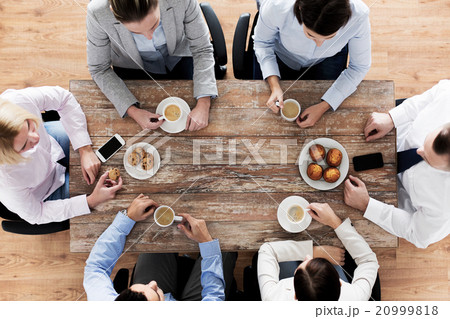close up of business team drinking coffee on lunch 20999818