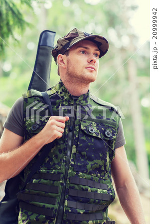 young soldier or hunter with gun in forest young soldier or hunter with gun in forest 20999942