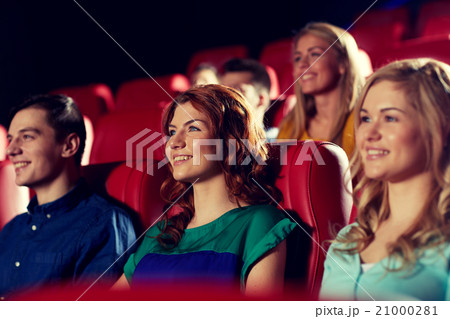 happy friends watching movie in theater 21000281