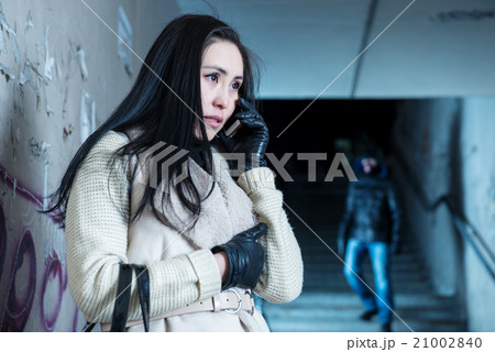 Young woman along at night at a danger 21002840