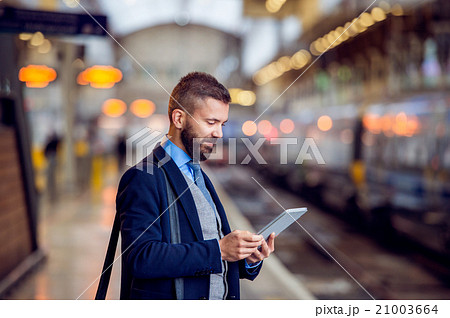 Hipster businessman with tablet, waiting, train Hipster businessman with tablet, waiting, train 21003664