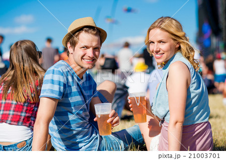 Young couple with beer at summer music festival Young couple with beer at summer music festival 21003701