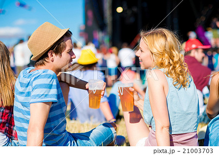 Young couple with beer at summer music festival 21003703