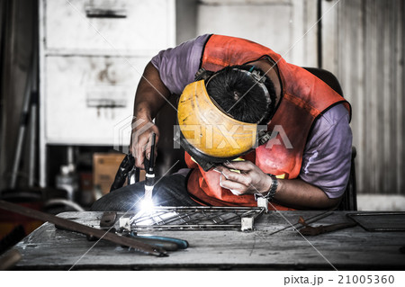 Technician using tig welder in factory's workshop 21005360