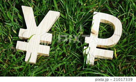 Exchange currency unit on a grass background Exchange currency unit on a grass background 21017339