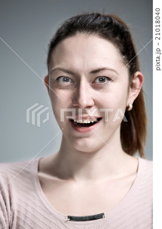 The happy woman on gray background The happy woman on gray background 21018040