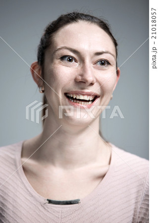 The happy woman on gray background The happy woman on gray background 21018057
