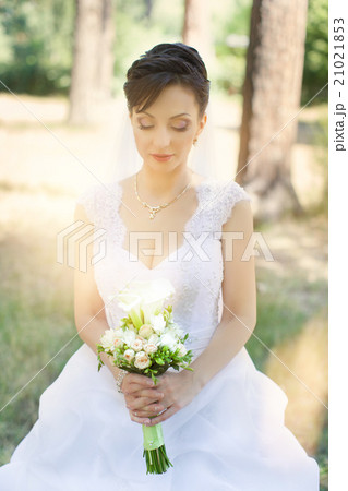 Brunette bride in a beautiful white dress Brunette bride in a beautiful white dress 21021853
