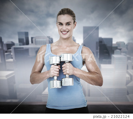 Composite image of muscular woman exercising with dumbbells 21022124