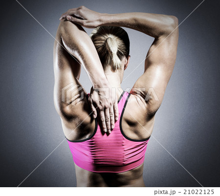 Composite image of muscular woman stretching her arms 21022125