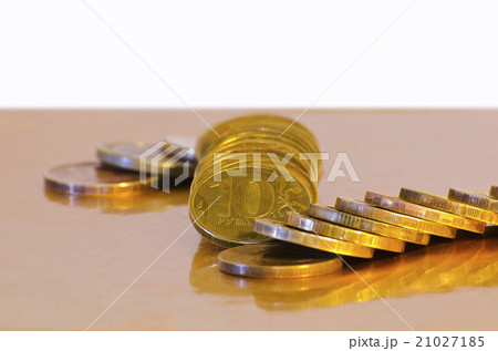 Stack of coins close-up on a gold background 21027185