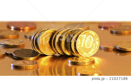 Stack of coins close-up on a gold background Stack of coins close-up on a gold background 21027186