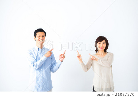 指さしする男性と女性　仲良し夫婦　男の人　女の人白背景　ポートレート　バック　コピースペース　 21027570