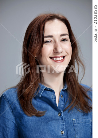 The happy woman on gray background 21028585