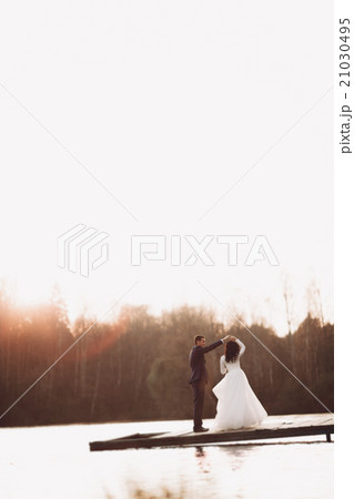 Elegant beautiful wedding couple posing near a Elegant beautiful wedding couple posing near a 21030495