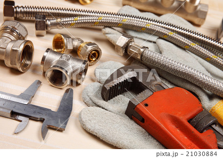 Set of plumbing and tools on the table. Set of plumbing and tools on the table. 21030884