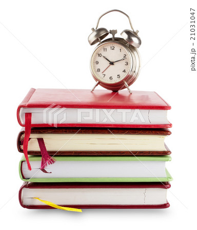 Stack of notebooks with bookmarks and alarm clock Stack of notebooks with bookmarks and alarm clock 21031047