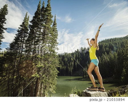 Mature woman standing on rock Mature woman standing on rock 21033894
