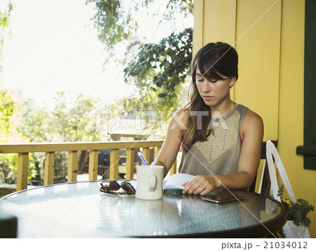 Young woman writing in diary Young woman writing in diary 21034012