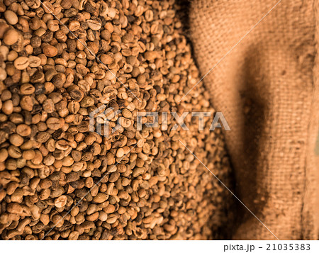 green unroasted coffee beans in sack. 21035383