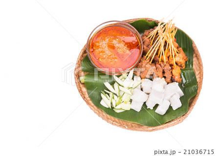 Barbecue satay served on traditional rattan plate 21036715