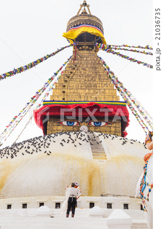 Devotee worshiping the sacred Boudhanath Stupa 21036735