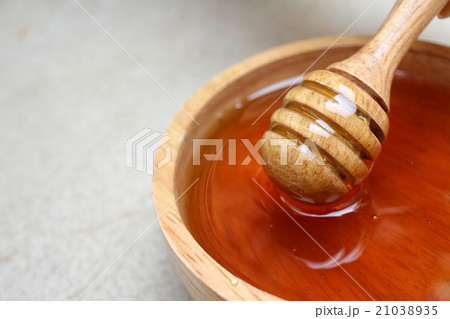 Fresh honey with honey dipper Fresh honey with honey dipper 21038935