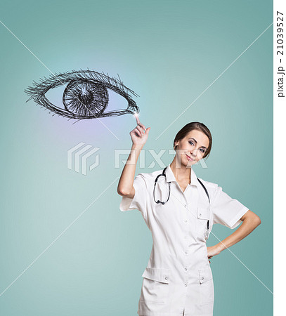 Female doctor in uniform touch painted human eye Female doctor in uniform touch painted human eye 21039527