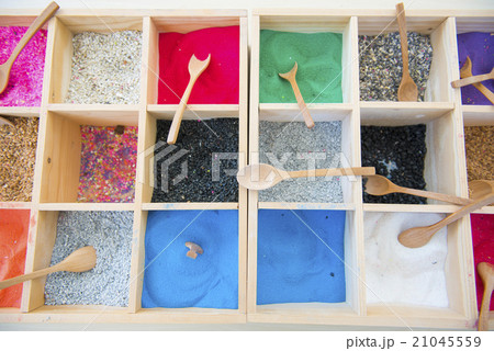 colorful sands and colorful rocks in wooden box colorful sands and colorful rocks in wooden box 21045559