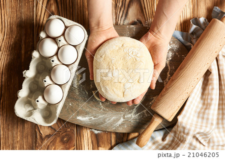 Female hands kneading dough 21046205