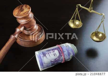 Judges Gavel, Scale Of Justice And Cash On Table Judges Gavel, Scale Of Justice And Cash On Table 21048877