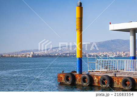 Yellow lighthouse pole on the pier in Izmir city 21083554