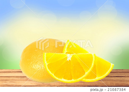 fresh lemon and slices on wooden table over nature 21087384