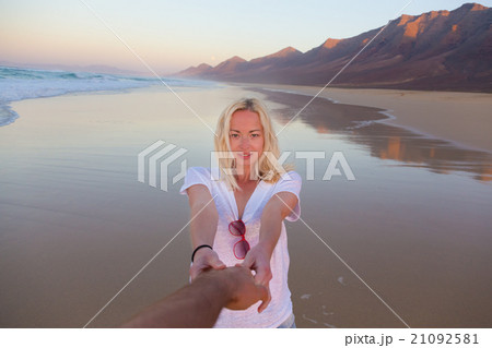 Romantic couple holding hands on beach. Romantic couple holding hands on beach. 21092581