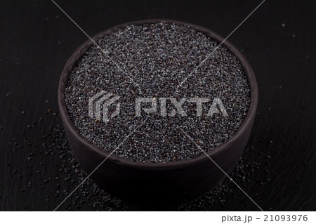 poppy seeds in a stone bowl 21093976