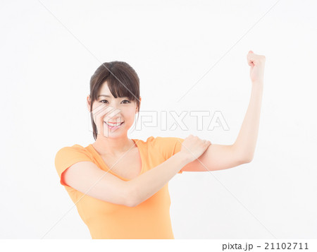 二の腕を触る女性の写真素材