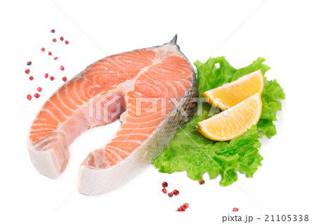 Raw salmon steak with lemon. 21105338