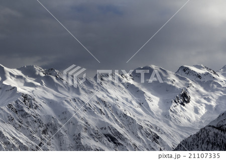 High snowy mountains and sunlight storm sky High snowy mountains and sunlight storm sky 21107335