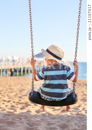 Funny toddler boy having fun on swing 21107817