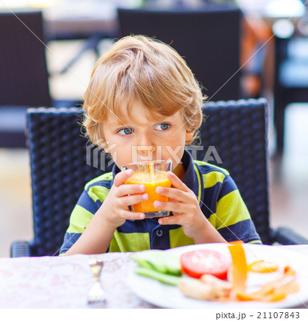 Little kid boy having healthy breakfast in 21107843