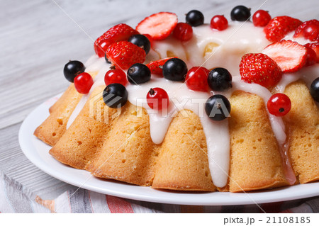 cake with icing and fresh strawberries and currant cake with icing and fresh strawberries and currant 21108185