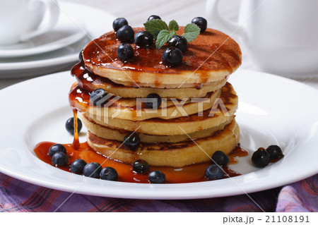 Pancake with blueberries, mint and maple syrup Pancake with blueberries, mint and maple syrup 21108191
