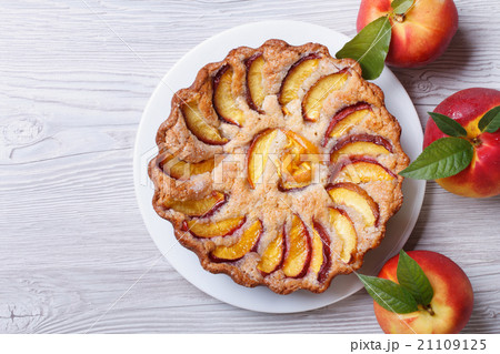 peach pie and fresh fruit on a wooden top view 21109125