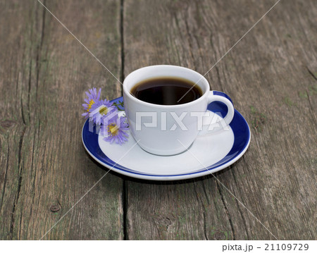 cup of coffee with a saucer decorated with flowers 21109729